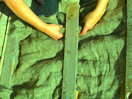 hands touching raw wool