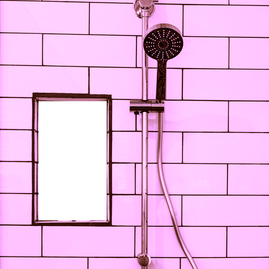 shower head on pink tiles