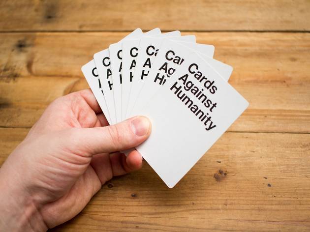 hand holding deck of cards against humanity